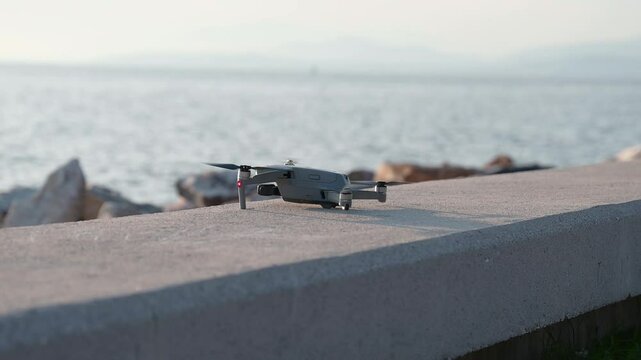 A drone is taking off against the backdrop of the sea