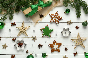 Christmas gingerbread cookies with star anise, gift box, fir branches and decorations on white...