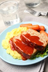 Delicious baked turkey meatloaf with mashed potato served on table, closeup