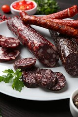 Different smoked sausages and spices on table, closeup