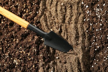 Shovel in fresh soil, closeup. Gardening tool