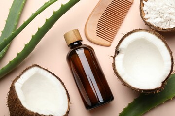 Hair treatment. Cosmetic product, coconut, butter shavings and aloe leaves on beige background,...