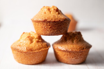 home baked lemon muffins on off white background