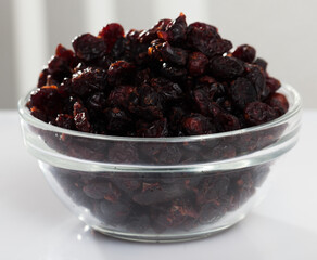 Natural dehydrated blueberries without sweeteners or preservatives in bowl. Healthy vitamin snack..