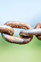 Fototapeta premium Rusty chain links close-up, outdoor setting, blurred background; strength, unity concept