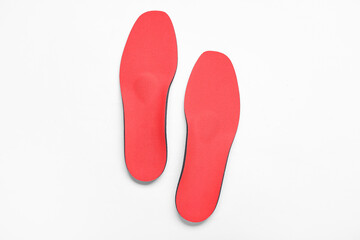 Red comfortable orthopedic insoles isolated on white background
