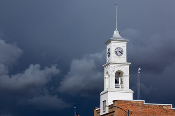 A clock tower in Illinois, with dark storm clouds.