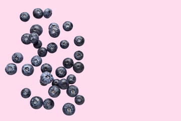 Flying fresh blueberries on pink background