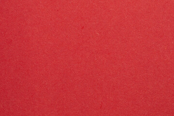 Fototapeta premium A red background with a white object in the middle, textured origami paper backdrop