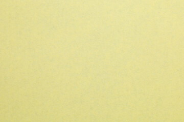 A yellow background with a white spot, textured origami paper backdrop