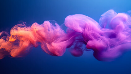 Obraz premium Colorful smoke swirls in vibrant display. Bright, swirling clouds of colored smoke blend in shades of purple and orange against a deep blue background.
