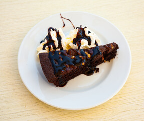 Sweet chocolate brownie cake on background of pieces for cafe or bakery menu