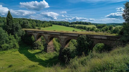 Ancient Roman aqueduct stretching across the countryside under a blue sky.