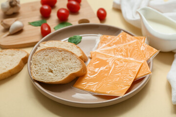 Plate with slices of tasty processed cheese, bread and tomatoes on board on beige background....