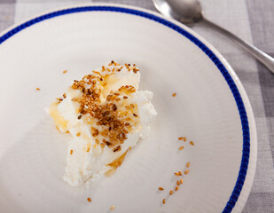 Homemade hearty breakfast - cottage cheese with honey sauce. dish is richly decorated with sesame...