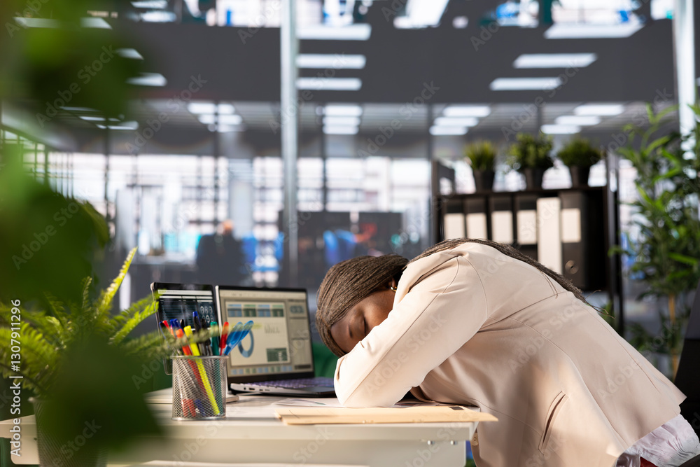 Poster office clerk falling asleep at computer desk while looking through financial business documents over