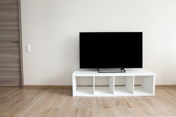 Lcd tv on white shef at modern room interior