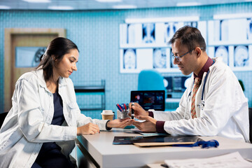 Fototapeta premium Medical expert administering insulin with injection pen to a patient during check up visit. Modern diagnostic tools and instruments are used in a healthcare consultation, health insurance.