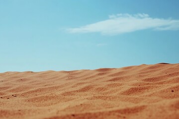 Fototapeta premium Close-up of soft sandy surface under clear blue sky with wispy clouds on a warm day : Generative AI