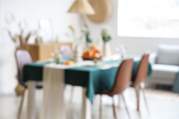 Dining table served with citrus fruits in room. Blurred view