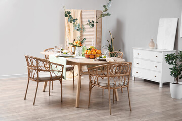 Dining table served with citrus fruits in room