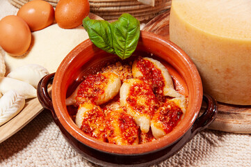 Culurgiones ravioli in tomato sauce, Sardinia, Italy