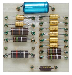 Overhead view of an aged electronic circuit board featuring resistors and capacitors, ideal for...