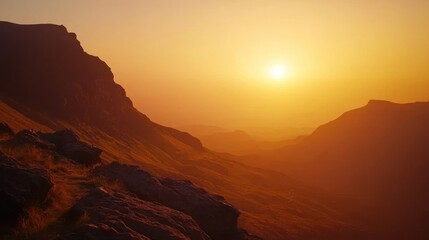 Naklejka premium Sunset over hazy mountain range.