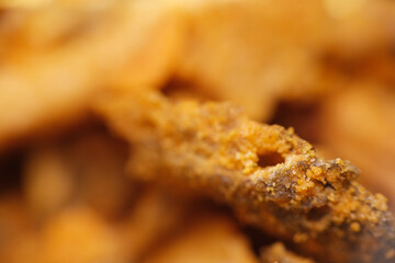 Close up texture of crispy fried salmon skin coated with salted egg powder