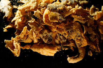 Close up texture of crispy fried salmon skin coated with salted egg powder