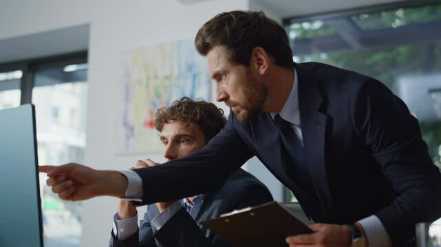 Man mentor helping colleague solving problem at office coworking space closeup