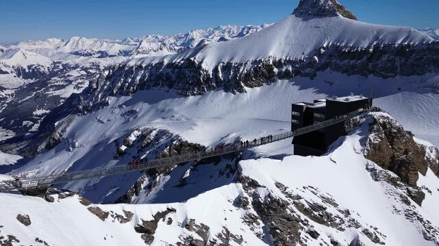 Panoramic Aerial View of Glacier 3000 with Alpine Peaks, Suspended Bridge (Peak Walk), Cable Car Lift, and Ski Resort at the Summit in Switzerland