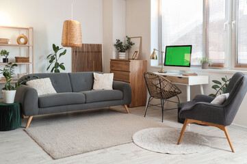 Interior of room with comfortable workplace and modern computer