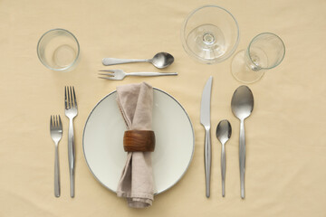 Beautiful table setting on beige background. Top view