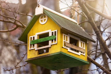 Beautiful wooden birdhouse in the winter garden