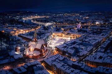 Aerial panorama of snow covered Podgorze district at night during winter in Krakow, Poland