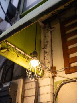 Rustic Japanese Alley with Hanging Warm Light Bulb at Night