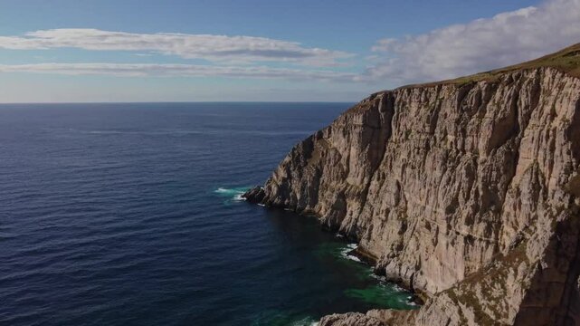 A Breathtaking Coastal View of Rugged Cliffs Dramatically Plunging into the Deep Blue Sea &ndash; Highlighting the Powerful Contrast Between the Rocky Shoreline and Calm Ocean in a Striking Natural 