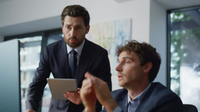 Office mentor learning intern at desk with computer closeup. Business meeting