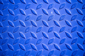 Blue patterned steel surface and rust.