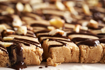 Closeup of homemade snack bars made of whey protein powder, ground oat flakes, maple syrup and nut butter