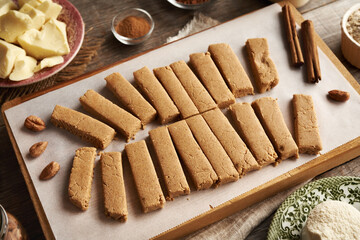 Homemade snack bars made of whey protein powder, ground oat flakes, maple syrup, cinnamon and nut butter