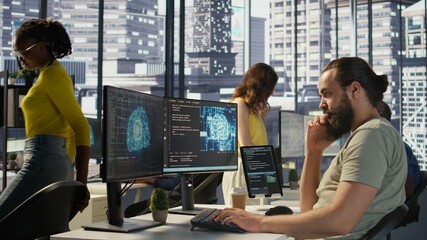 Employee utilizing AI resources and platforms to train and deploy machine learning models, handheld...