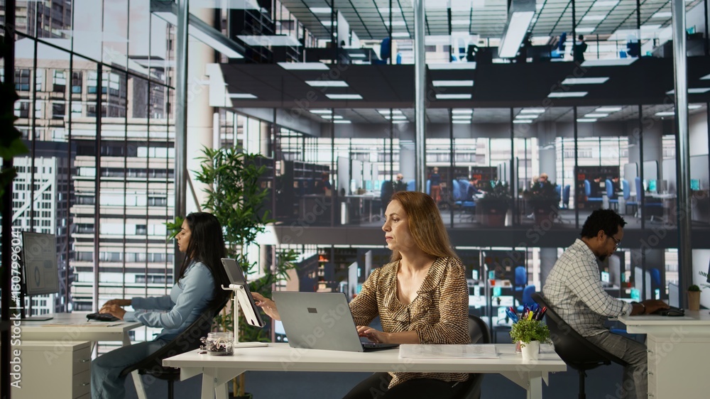 Aufkleber female executive reviewing business operations at her desk, focused on project management. employee 