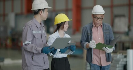 A team of engineers professionals engages with a client during a consultation session at a bustling metal sheet factory, discussing project specifics and industry solutions.
