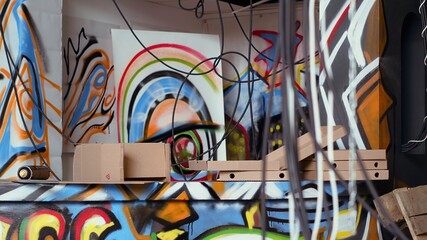 Colorful basement filled with graffiti art used as hanging place by skaters, urban culture concept. Artsy abandoned building filled with paint artworks by teenagers, hip hop lifestyle