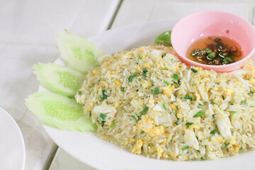 Crab Fried rice with spicy fish sauce and cucumber on white plate. Thai seafood style Asia Thailand Food.