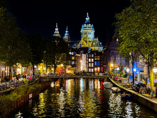 Naklejka premium Beautiful aerial view of Amsterdam Stichting Muziek in de Nicolaas near the Centraal Train Station and its historic hub with canals, bikes, cafes. Netherlands 