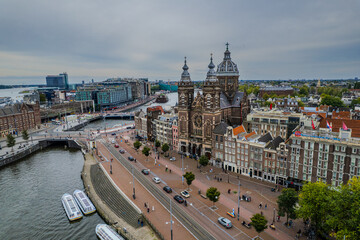 Beautiful aerial view of Amsterdam Stichting Muziek in de Nicolaas near the Centraal Train Station and its historic hub with canals, bikes, cafes. Netherlands 