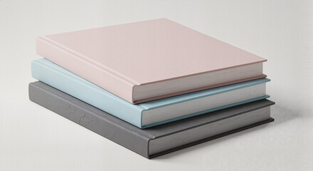 Stack of three colored books on a light background, book stack mockup